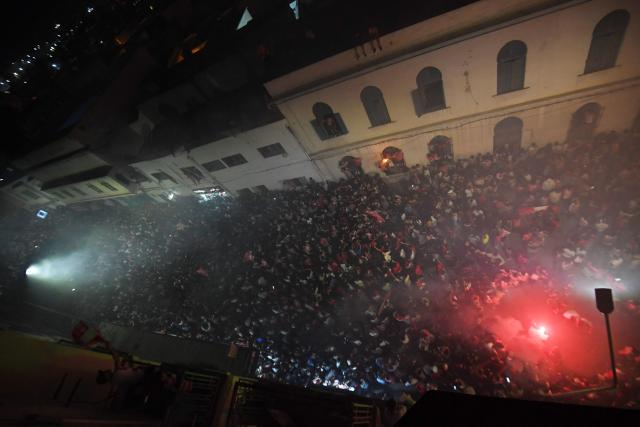 Fans light flares during the victory ceremony of the Club Africain football team in the 2025/2026 Tunisian Ligue 1 championship, in Tunis on May 14, 2026. (Photo by FETHI BELAID / AFP)