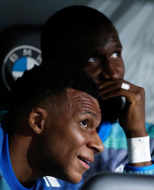 Real Madrid's French forward #10 Kylian Mbappe (L) and Real Madrid's German defender #22 Antonio Ruediger are pictured in the bench before the Spanish league football match between Real Madrid CF and Real Oviedo at Santiago Bernabeu Stadium in Madrid on May 14, 2026. (Photo by Oscar DEL POZO / AFP)