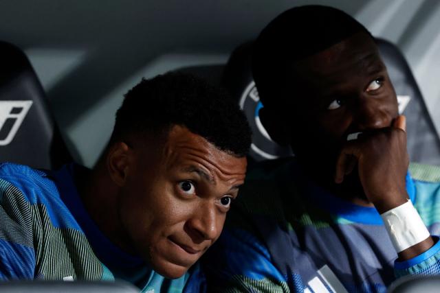 Real Madrid's French forward #10 Kylian Mbappe (L) and Real Madrid's German defender #22 Antonio Ruediger are pictured in the bench before the Spanish league football match between Real Madrid CF and Real Oviedo at Santiago Bernabeu Stadium in Madrid on May 14, 2026. (Photo by Oscar DEL POZO / AFP)