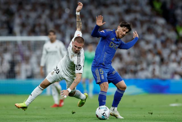 Real Madrid's Argentinian midfielder #30 Franco Mastuantono and Real Oviedo's Spanish midfielder #05 Alberto Reina fight for the ball during the Spanish league football match between Real Madrid CF and Real Oviedo at Santiago Bernabeu Stadium in Madrid on May 14, 2026. (Photo by Oscar DEL POZO / AFP)