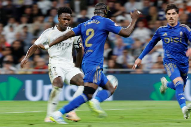 Real Madrid's Brazilian forward #07 Vinicius Junior and Real Oviedo's Ivorian defender #02 Eric Bailly vie for the ball during the Spanish league football match between Real Madrid CF and Real Oviedo at Santiago Bernabeu Stadium in Madrid on May 14, 2026. (Photo by Oscar DEL POZO / AFP)