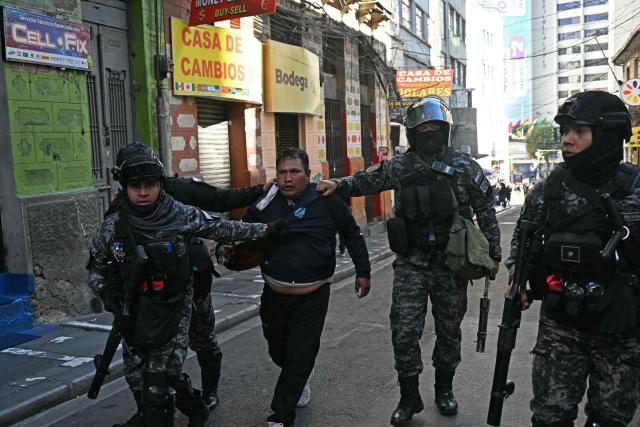 Riot police deatain a miners after clashes erupted during a march to demand the resignation of Bolivian President Rodrigo Paz in La Paz, on May 14, 2026. For the past two weeks, workers, farmers, school teachers, Indigenous groups and transport workers have been pressuring the government. Their demands range from wage increases and economic stabilization to opposition to the privatization of public companies. (Photo by AIZAR RALDES / AFP)