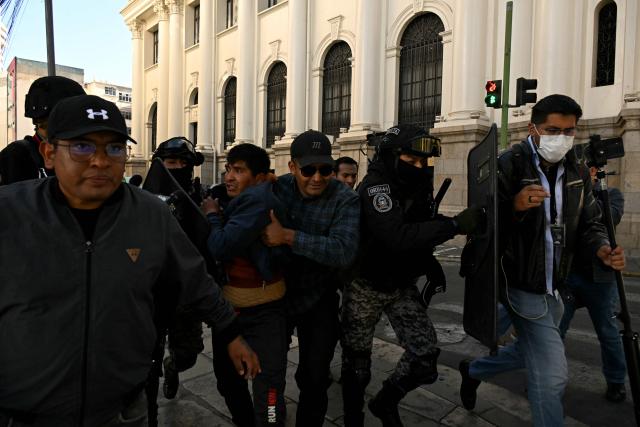 Police detain a miner after clashes erupted during a march to demand the resignation of Bolivian President Rodrigo Paz in La Paz, on May 14, 2026. For the past two weeks, workers, farmers, school teachers, Indigenous groups and transport workers have been pressuring the government. Their demands range from wage increases and economic stabilization to opposition to the privatization of public companies. (Photo by AIZAR RALDES / AFP)