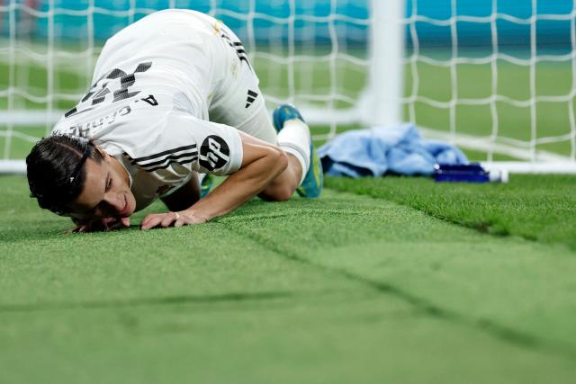 Real Madrid's Spanish defender #18 Alvaro Carreras falls down to the ground during the Spanish league football match between Real Madrid CF and Real Oviedo at Santiago Bernabeu Stadium in Madrid on May 14, 2026. (Photo by Oscar DEL POZO / AFP)