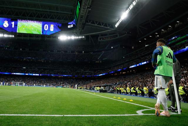 Real Madrid's French forward #10 Kylian Mbappe watches the game from the corner as he warms up during the Spanish league football match between Real Madrid CF and Real Oviedo at Santiago Bernabeu Stadium in Madrid on May 14, 2026. (Photo by Oscar DEL POZO / AFP)
