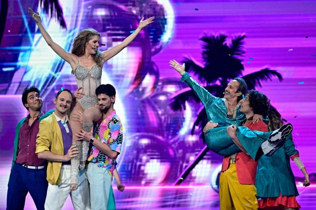 Austrian presenters Victoria Swarovski (top L) and Michael Ostrowski (top R) perform during the second semi-final of the Eurovision Song Contest 2026 (ESC) at Wiener Stadthalle in Vienna, Austria on May 14, 2026. (Photo by Tobias SCHWARZ / AFP)