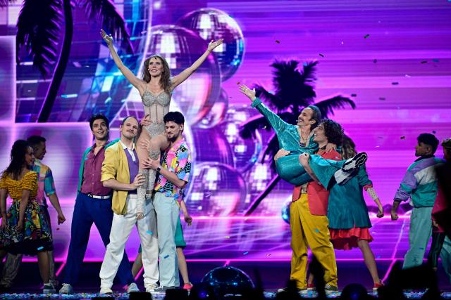 Austrian presenters Victoria Swarovski (top L) and Michael Ostrowski (top R) perform during the second semi-final of the Eurovision Song Contest 2026 (ESC) at Wiener Stadthalle in Vienna, Austria on May 14, 2026. (Photo by Tobias SCHWARZ / AFP)