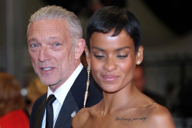 French actor Vincent Cassel and his partner Brazilian model Narah Baptista leave after the screening of the film "Histoires Paralleles" (Parallel Tales) at the 79th edition of the Cannes Film Festival in Cannes, southern France on May 14, 2026. (Photo by Sameer AL-DOUMY / AFP)