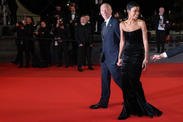 French actor Vincent Cassel and his partner Brazilian model Narah Baptista leave after the screening of the film "Histoires Paralleles" (Parallel Tales) at the 79th edition of the Cannes Film Festival in Cannes, southern France on May 14, 2026. (Photo by Sameer AL-DOUMY / AFP)