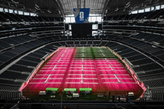 Dallas Stadium (temporarily renamed from AT&T Stadium for the 2026 FIFA World Cup) is seen with purple lights illuminating the field to promote grass growth, in Arlington, Texas, on May 14, 2026. (Photo by RONALDO SCHEMIDT / AFP)