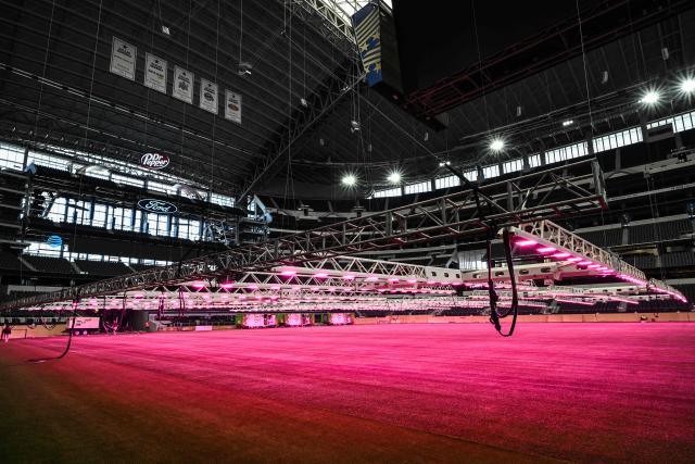 Dallas Stadium (temporarily renamed from AT&T Stadium for the 2026 FIFA World Cup) is seen with purple lights illuminating the field to promote grass growth, in Arlington, Texas, on May 14, 2026. (Photo by RONALDO SCHEMIDT / AFP)