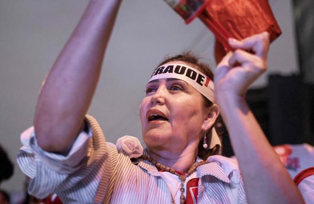 A supporter of Peru's presidential candidate for the Renovacion Popular party, Rafael Lopez Aliaga, shouts slogans during a rally to protest alleged irregularities in the recent elections in Lima on May 14, 2026. (Photo by Connie FRANCE / AFP)