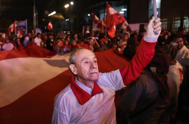 A supporter of Peru's presidential candidate for the Renovacion Popular party, Rafael Lopez Aliaga, attends a rally to protest alleged irregularities in the recent elections in Lima on May 14, 2026. (Photo by Connie FRANCE / AFP)