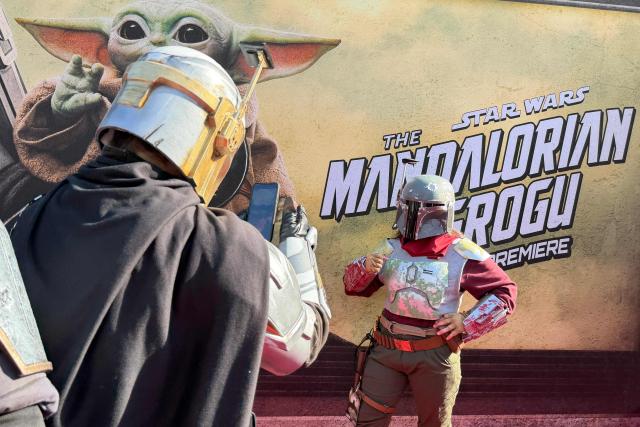 Cosplayers dressed as Mandalorians are seen at the world premiere of "Star Wars: The Mandalorian and Grogu" at the TCL Chinese Theatre in Los Angeles on May 14, 2026. (Photo by Chris DELMAS / AFP)