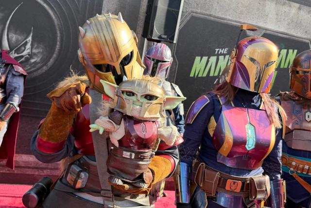 Cosplayers dressed as Mandalorians are seen at the world premiere of "Star Wars: The Mandalorian and Grogu" at the TCL Chinese Theatre in Los Angeles on May 14, 2026. (Photo by Chris DELMAS / AFP)