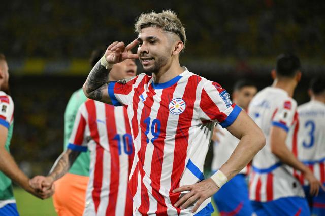 (FILES) Paraguay's forward #19 Julio Enciso celebrates after scoring during the 2026 FIFA World Cup South American qualifiers football match between Colombia and Paraguay at the Metropolitano Roberto Melendez stadium in Barranquilla, Colombia, on March 25, 2025. Those who know him attest that Julio Enciso fears no challenges, nor does he ever lose touch with his roots. That "mita'i" (little boy)—who once spoke more Guaranн than Spanish—is today not only a 22-year-old man, but also Paraguay's hope for its return to the World Cup. (Photo by Luis ACOSTA / AFP)