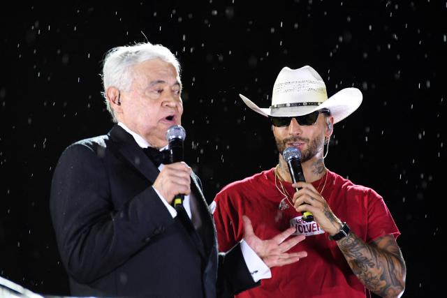 Colombian television presenter Jorge Baron (L) and singer Maluma (R) speak during the launch of Maluma's new album 'Loco x Volver' in Medellin, Colombia on May 14, 2026. (Photo by Jaime SALDARRIAGA / AFP)