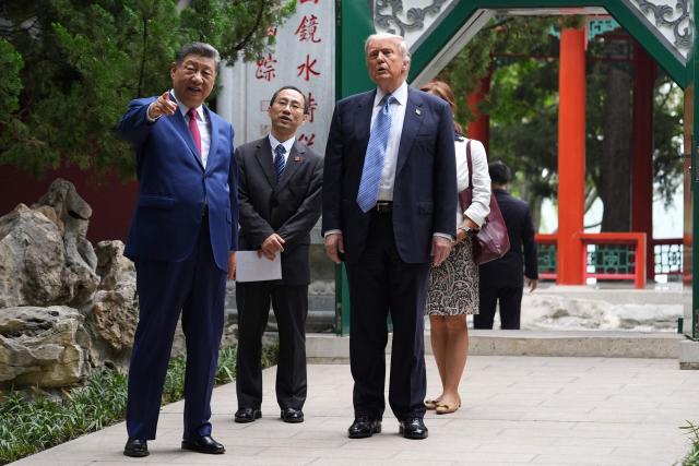 US President Donald Trump (R) and China’s President Xi Jinping (L) visit the Zhongnanhai leadership compound in Beijing on May 15, 2026. (Photo by Mark Schiefelbein / POOL / AFP)