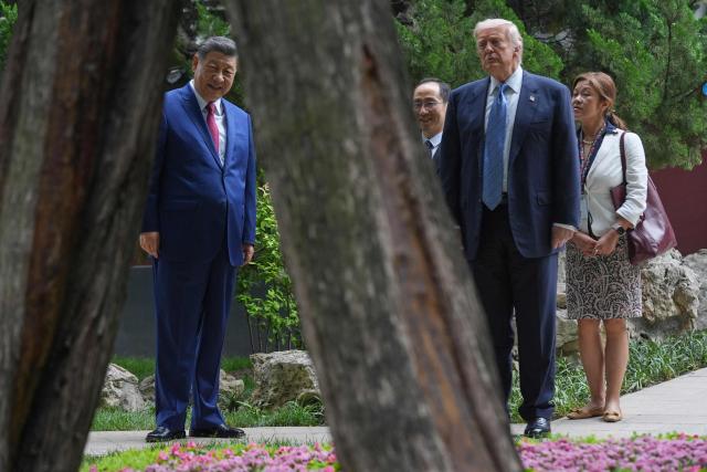 US President Donald Trump (2nd R) and China’s President Xi Jinping (L) visit the Zhongnanhai leadership compound in Beijing on May 15, 2026. (Photo by Mark Schiefelbein / POOL / AFP)