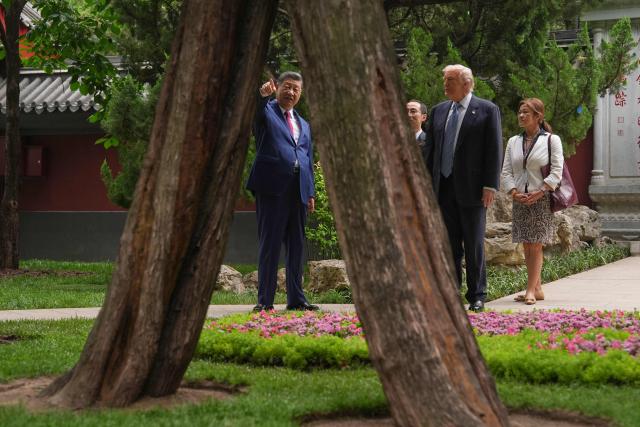 US President Donald Trump (2nd R) talks to China’s President Xi Jinping (L) at the Zhongnanhai leadership compound in Beijing on May 15, 2026. (Photo by Mark Schiefelbein / POOL / AFP)