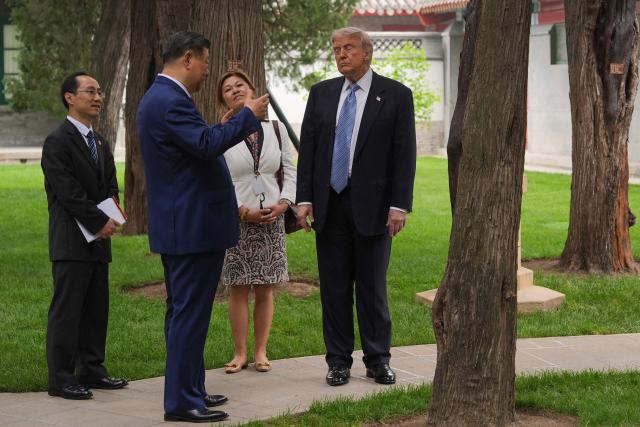 US President Donald Trump (R) talks to China’s President Xi Jinping (2nd L) at the Zhongnanhai leadership compound in Beijing on May 15, 2026. (Photo by Mark Schiefelbein / POOL / AFP)