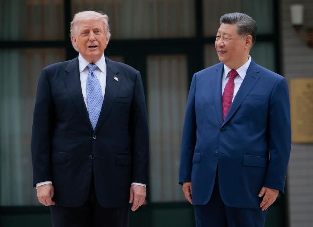US President Donald Trump (L) poses for photos with China’s President Xi Jinping during a visit to Zhongnanhai Garden in Beijing on May 15, 2026. (Photo by Evan Vucci / POOL / AFP)