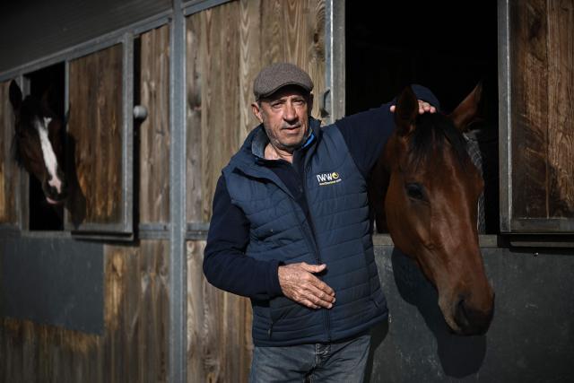 (FILES) French horse riding trainer Francois Nicolle poses before a training session in Saint-Augustin-sur-Mer, southwestern France, on May 3, 2022. François Nicolle, one of France's top three jump racing trainers, won the Grand Steeple-Chase de Paris in 2025 with his charge Diamond Carl, ridden by Clement Lefevbre. Based in Saint-Augustin at his private training centre, the Charente native works with his wife and a team of 40 staff to look after around a hundred horses. This year, he will attempt to double his success in this 6km marathon race featuring 23 obstacles. A man who thrives on a challenge, he hopes to win with the six-year-old Kentucky Wood. (Photo by Philippe LOPEZ / AFP)