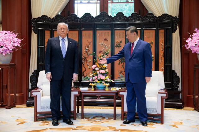 US President Donald Trump (L) meets with China’s President Xi Jinping on the sidelines of their visit to Zhongnanhai Garden in Beijing on May 15, 2026. (Photo by Evan Vucci / POOL / AFP)