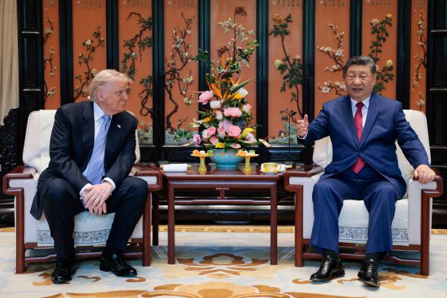 US President Donald Trump (L) meets with China’s President Xi Jinping on the sidelines of their visit to Zhongnanhai Garden in Beijing on May 15, 2026. (Photo by Evan Vucci / POOL / AFP)