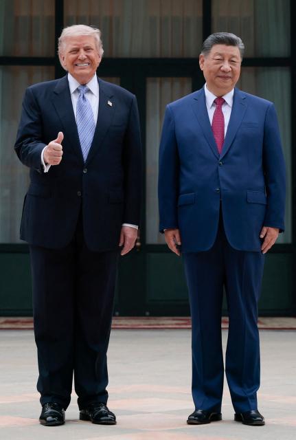 US President Donald Trump (L) poses for photos with China’s President Xi Jinping during a visit to Zhongnanhai Garden in Beijing on May 15, 2026. (Photo by Evan Vucci / POOL / AFP)