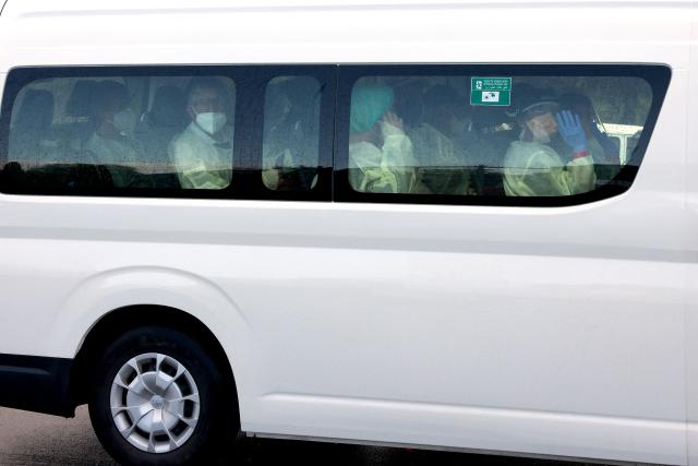 A bus carrying passengers caught up in the MV Hondius hantavirus outbreak, arrives at a purpose-built quarantine facility located on the outskirts of the Western Australian city of Perth on May 15, 2026. A plane carrying six passengers caught up in the hantavirus outbreak on the MV Hondius cruise ship landed May 15 at a military airbase in western Australia, where they will immediately enter a strict three-week quarantine. (Photo by Antony DICKSON / AFP)
