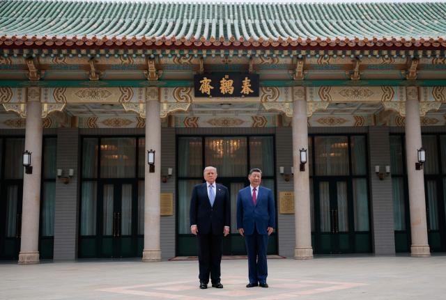 US President Donald Trump (L) poses for photos with China’s President Xi Jinping during a visit to Zhongnanhai Garden in Beijing on May 15, 2026. (Photo by Evan Vucci / POOL / AFP)