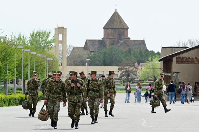 Armenian servicemen walk in Echmiadzin, Armenia's ancient spiritual centre and the seat of the leader of the Armenian Apostolic Church, outside Yerevan, on April 18, 2026. (Photo by KAREN MINASYAN / AFP)