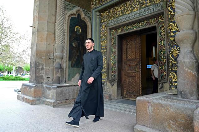 A clergyman walks in Echmiadzin, Armenia's ancient spiritual centre and the seat of the leader of the Armenian Apostolic Church, outside Yerevan, on April 18, 2026. (Photo by KAREN MINASYAN / AFP)
