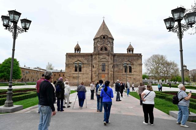 People gather outside the Etchmiadzin Cathedral in Echmiadzin, Armenia's ancient spiritual centre and the seat of the leader of the Armenian Apostolic Church, outside Yerevan, on April 18, 2026. (Photo by KAREN MINASYAN / AFP)