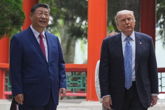 US President Donald Trump (R) and China’s President Xi Jinping (L) visit the Zhongnanhai leadership compound in Beijing on May 15, 2026. (Photo by Mark Schiefelbein / POOL / AFP)