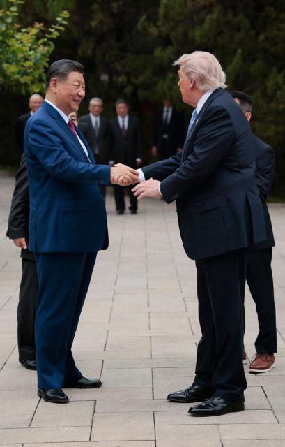 US President Donald Trump (R) shakes hands with China’s President Xi Jinping as he leaves after a visit to Zhongnanhai Garden in Beijing on May 15, 2026. (Photo by Evan Vucci / POOL / AFP)
