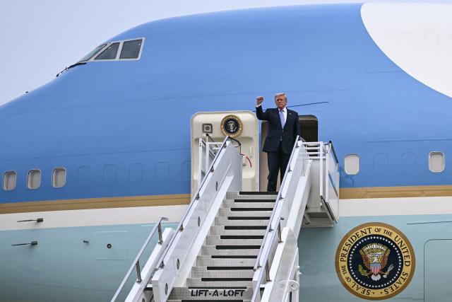 US President Donald Trump boards Air Force One before his departure from Beijing Capital Airport in Beijing on May 15, 2026. Trump said he had made "fantastic trade deals" with China's Xi Jinping, as the pair met on May 15 at final talks of a superpower summit that according to the US leader has also reaped a Chinese offer to help open the Strait of Hormuz. (Photo by Brendan SMIALOWSKI / AFP)