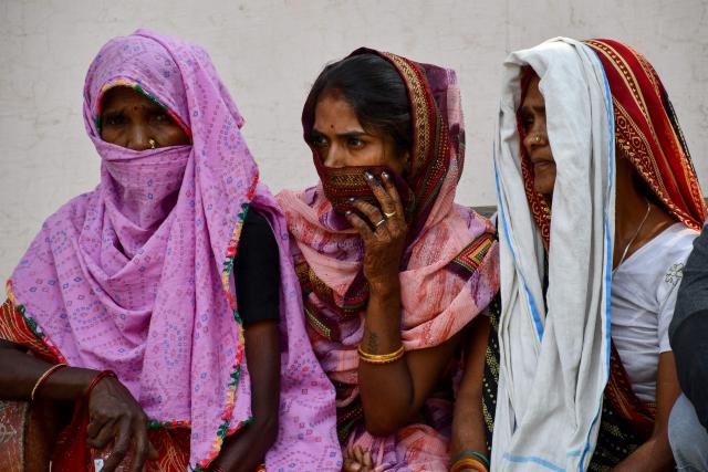 Relatives wait outside the mortuary at Swaroop Rani Nehru (SRN) Hospital to receive the bodies of victims who lost their lives following a heavy storm in Prayagraj on May 14, 2026. Powerful storms that swept across India's northern Uttar Pradesh state this week killed at least 111 people, government officials said, raising an earlier death toll as more districts reported casualties. (Photo by AFP)