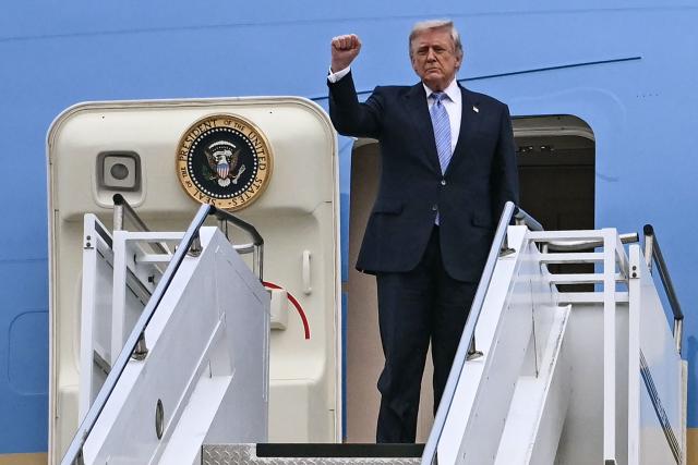 US President Donald Trump boards Air Force One before his departure from Beijing Capital Airport in Beijing on May 15, 2026. Trump said he had made "fantastic trade deals" with China's Xi Jinping, as the pair met on May 15 at final talks of a superpower summit that according to the US leader has also reaped a Chinese offer to help open the Strait of Hormuz. (Photo by Brendan SMIALOWSKI / AFP)
