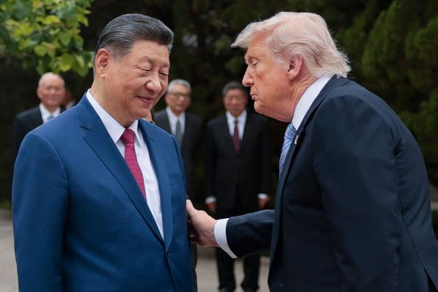 US President Donald Trump (R) gestures to China’s President Xi Jinping as he leaves after a visit to Zhongnanhai Garden in Beijing on May 15, 2026. (Photo by Evan Vucci / POOL / AFP)