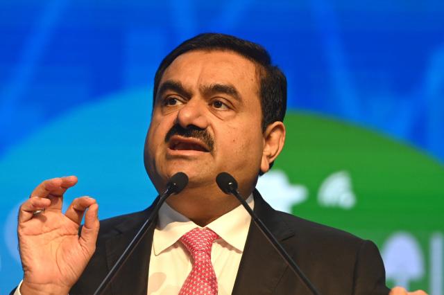 (FILES) Chairperson of Indian conglomerate Adani Group, Gautam Adani, speaks at the World Congress of Accountants in Mumbai on November 19, 2022. Indian billionaire industrialist Gautam Adani has agreed to pay a multi-million-dollar settlement in a US civil court case linked to corruption without admitting guilt, his company said on May 15, 2026. (Photo by Indranil MUKHERJEE / AFP)