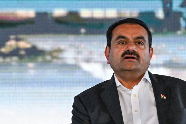 (FILES) Chairperson of the Indian conglomerate Adani Group, Gautam Adani, attends the inauguration ceremony of phase one of the Navi Mumbai International Airport in Navi Mumbai on October 8, 2025. Indian billionaire industrialist Gautam Adani has agreed to pay a multi-million-dollar settlement in a US civil court case linked to corruption without admitting guilt, his company said on May 15, 2026. (Photo by Punit PARANJPE / AFP)