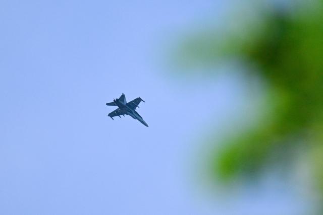 A Hornet fighter of the Finnish Air Force flies above Helsinki on May 15, 2026 after safety authorities issued a danger alert for the southern Uusimaa region over a potential drone in the area. Helsinki Airport resumed normal flight operations on May 15 after suspending air traffic for three hours due to a drone warning, officials said. (Photo by Markku Ulander / Lehtikuva / AFP) / Finland OUT