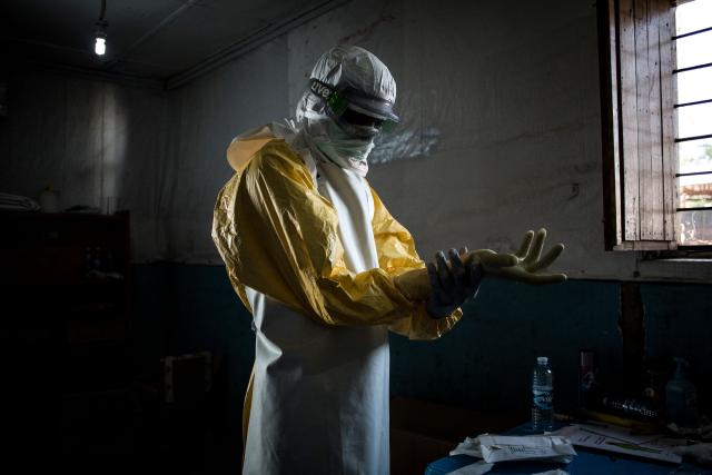 (FILES) A health worker puts on his personal protective equipment (PPE) before entering the red zone of a MSF (Doctors Without Birders) supported Ebola Treatment Centre (ETC), where he will check up on patients on November 6, 2018 in Bunia, Democratic Republic of the Congo. An outbreak of the ebola virus has been blamed for dozens of deaths in the east of the Democratic Republic of the Congo, African health authorities said on May 15, 2026.
The outbreak is in Ituri province. (Photo by John WESSELS / AFP)