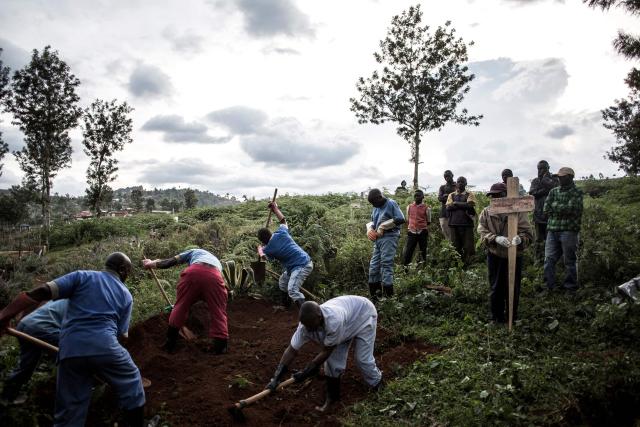 (FILES) Family members look on as they watch the deceased victim of the Ebola virus being buried on May 16, 2019 in Butembo. An outbreak of the ebola virus has been blamed for dozens of deaths in the east of the Democratic Republic of the Congo, African health authorities said on May 15, 2026.
The outbreak is in Ituri province. (Photo by JOHN WESSELS / AFP)