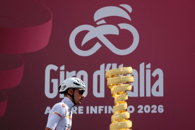UAE Team Emirates - XRG Spanish rider Igor Arrieta walks past the Giro d'Italia trophy ("trofeo senza fine") during the presentation prior the 7th stage of the Giro d'Italia 2026 - Tour of Italy cycling race between Formia and Blockhaus, Italy, on May 15, 2026. (Photo by Luca Bettini / AFP)