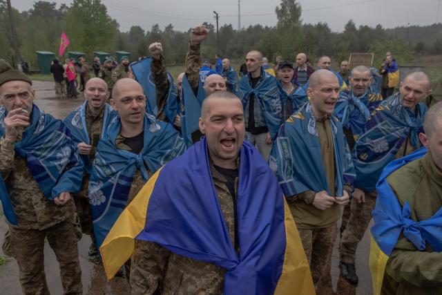 Released Ukrainian prisoners of war (POWs) react following a prisoner exchange at an undisclosed location, in the Chernihiv region on May 15, 2026, amid the Russian invasion of Ukraine. Russia and Ukraine exchanged 205 prisoners of war each on May 15, Moscow and Kyiv said, a week after US President Donald Trump announced a large swap would take place between the warring sides. (Photo by Roman PILIPEY / AFP)