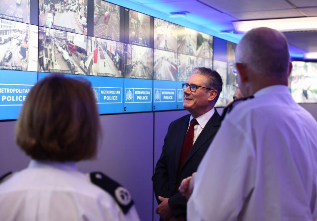Britain's Prime Minister Keir Starmer looks at images from CCTV cameras located across London, as he meets with Metropolitan police officers to discuss operational planning ahead of this weekend's planned protests, in the Lambeth area of London on May 15, 2026. (Photo by Peter Nicholls / POOL / AFP)