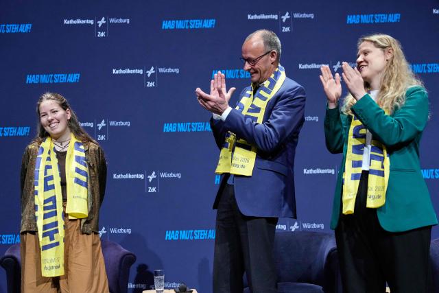 German Chancellor Friedrich Merz (C) arrives on stage to attend a panel discussion with young people during the “Deutscher Katholikentag”, a congress of the German Catholic people, in Wuerzburg, southern Germany, on May 15, 2026. (Photo by Matthias Schrader / POOL / AFP)